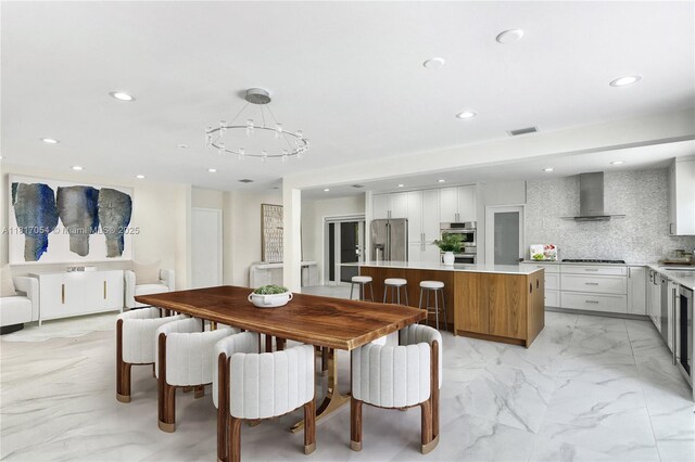 12985 Ortega Ln, North Miami, FL 33181 - dining room with light marble finish floors, recessed lighting, and a chandelier