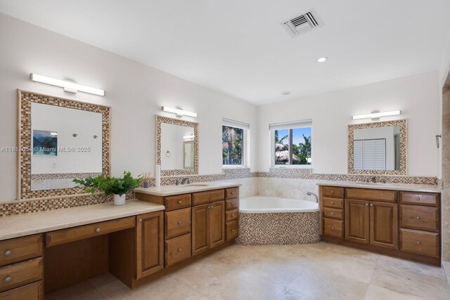 12985 Ortega Ln, North Miami, FL 33181 - bathroom with a garden tub, two vanities, and tile patterned flooring