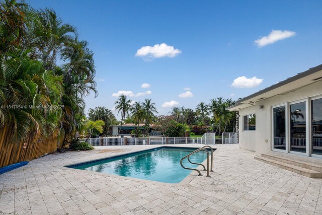12985 Ortega Ln, North Miami, FL 33181 - view of swimming pool featuring a patio
