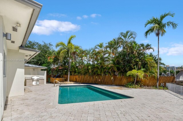 12985 Ortega Ln, North Miami, FL 33181 - view of swimming pool with a patio area and a fenced backyard