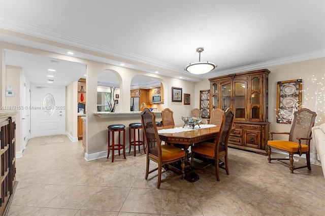 150 S Hollybrook Ter Unit 201, Pembroke Pines, FL 33025 - dining room featuring ornamental molding, arched walkways, recessed lighting, baseboards, and light tile patterned floors