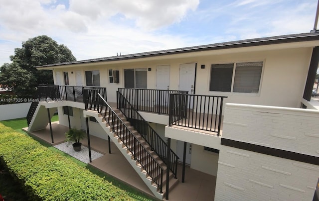 251 NW 57th Ave, Miami, FL 33126 - back of property featuring stairs and stucco siding