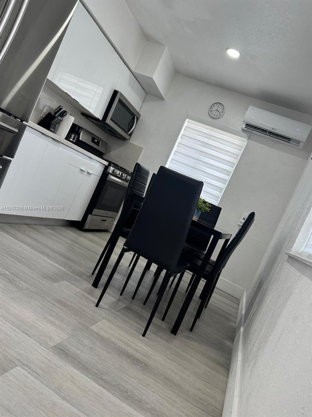 251 NW 57th Ave, Miami, FL 33126 - dining space featuring an AC wall unit, light wood-type flooring, and recessed lighting