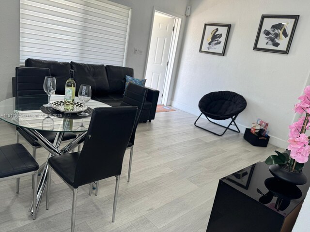 251 NW 57th Ave, Miami, FL 33126 - dining area featuring baseboards and light wood-style floors