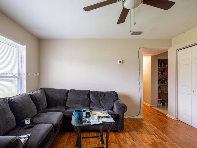 4915 Pine Needle Dr, Orlando, FL 32808 - living room featuring light wood finished floors, ceiling fan, and baseboards