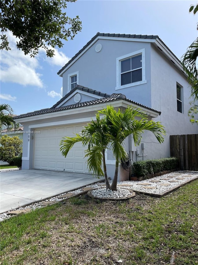 1100 SE 19th Ave, Homestead, FL 33035 - view of front of property with concrete driveway, stucco siding, and a tiled roof