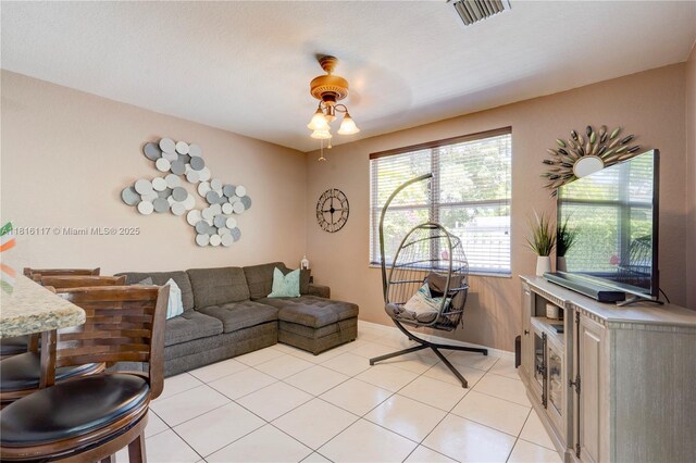 1100 SE 19th Ave, Homestead, FL 33035 - living area with a ceiling fan and light tile patterned flooring