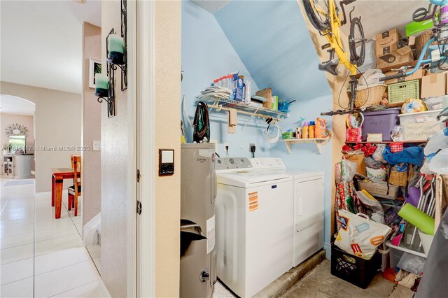 1100 SE 19th Ave, Homestead, FL 33035 - laundry area featuring washing machine and dryer, arched walkways, and light tile patterned floors