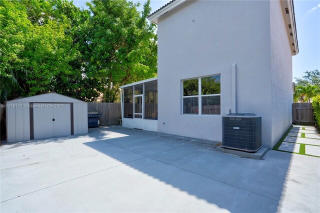 1100 SE 19th Ave, Homestead, FL 33035 - fenced backyard with a storage unit, a sunroom, and a patio