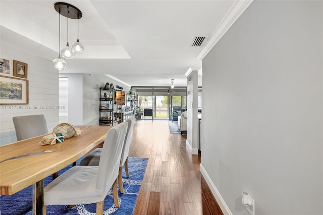 1100 SE 5th Ct Unit 87, Pompano Beach, FL 33060 - dining area with wood finished floors, ornamental molding, and baseboards