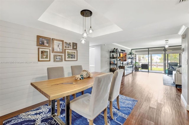 1100 SE 5th Ct Unit 87, Pompano Beach, FL 33060 - dining room featuring wood finished floors, a raised ceiling, and wooden walls