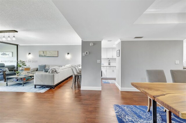 1100 SE 5th Ct Unit 87, Pompano Beach, FL 33060 - living area featuring crown molding, dark wood-type flooring, and baseboards