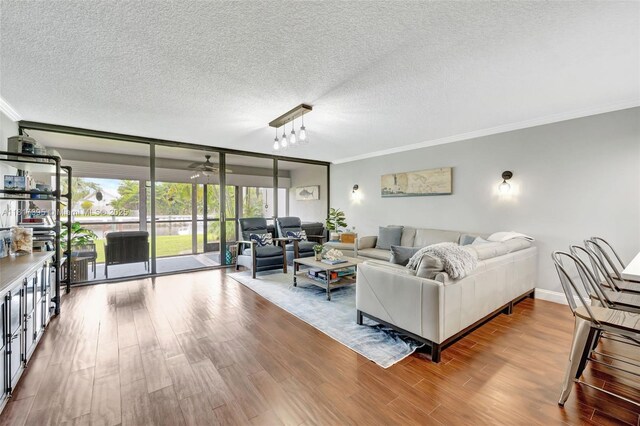 1100 SE 5th Ct Unit 87, Pompano Beach, FL 33060 - living area featuring crown molding, wood finished floors, a textured ceiling, ceiling fan, and expansive windows