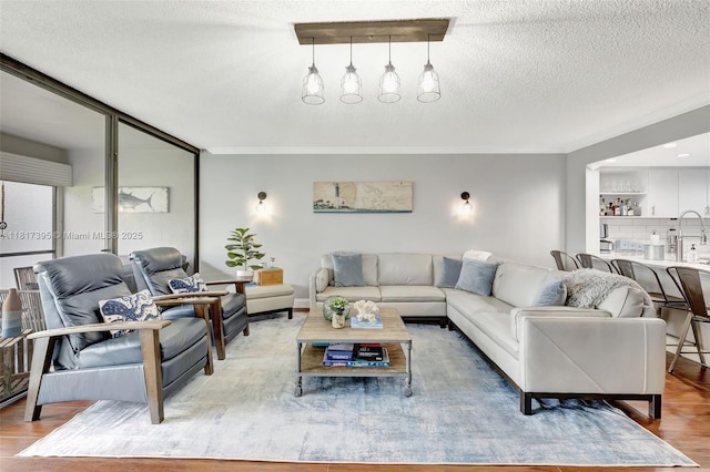 1100 SE 5th Ct Unit 87, Pompano Beach, FL 33060 - living area with ornamental molding, light wood-type flooring, and a textured ceiling