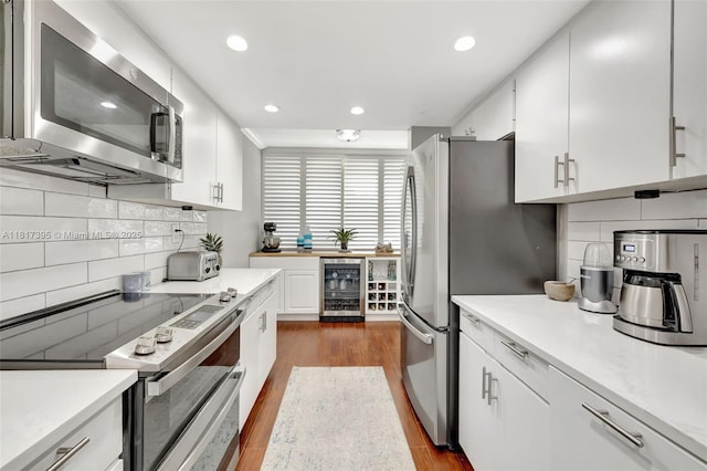 1100 SE 5th Ct Unit 87, Pompano Beach, FL 33060 - kitchen with appliances with stainless steel finishes, wine cooler, dark wood-style floors, light countertops, and recessed lighting