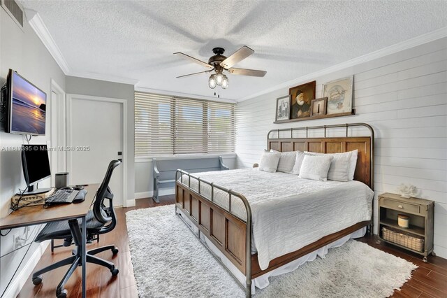 1100 SE 5th Ct Unit 87, Pompano Beach, FL 33060 - bedroom with dark wood-style flooring, crown molding, a textured ceiling, a desk, and wooden walls