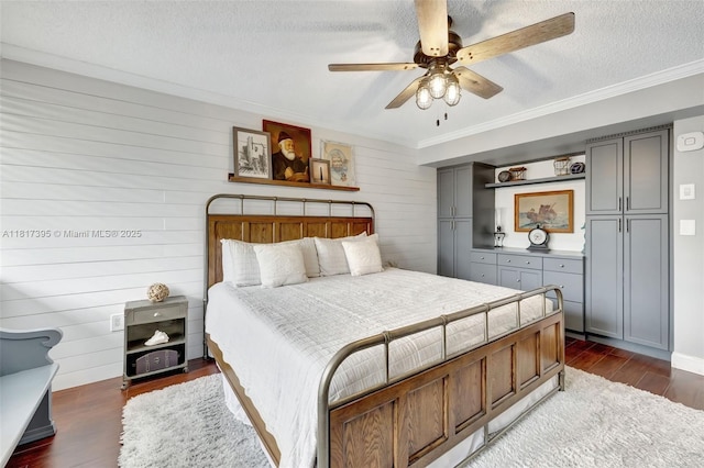 1100 SE 5th Ct Unit 87, Pompano Beach, FL 33060 - bedroom with dark wood-type flooring, a textured ceiling, crown molding, wood walls, and a ceiling fan