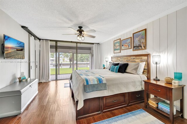1100 SE 5th Ct Unit 87, Pompano Beach, FL 33060 - bedroom with access to outside, a textured ceiling, wood finished floors, ceiling fan, and ornamental molding