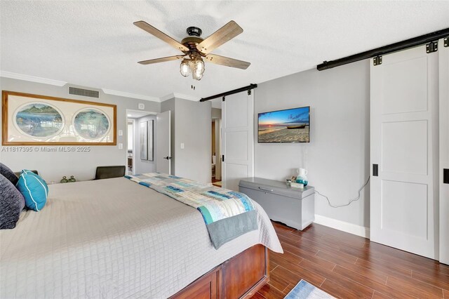 1100 SE 5th Ct Unit 87, Pompano Beach, FL 33060 - bedroom with a barn door, dark wood-style floors, baseboards, crown molding, and a ceiling fan