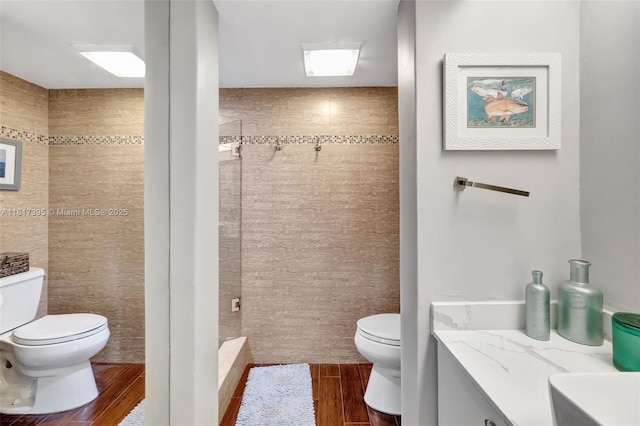 1100 SE 5th Ct Unit 87, Pompano Beach, FL 33060 - full bath with toilet, wood finished floors, tiled shower, vanity, and tile walls