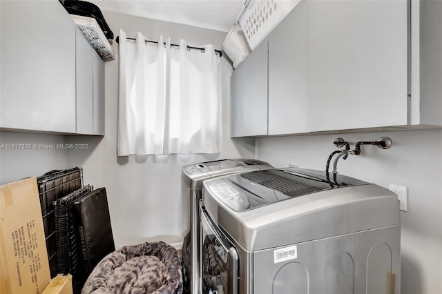 1100 SE 5th Ct Unit 87, Pompano Beach, FL 33060 - laundry room featuring separate washer and dryer, a textured ceiling, and cabinet space