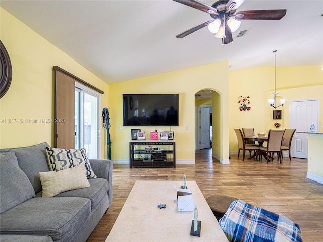 508 Arcadia Ave NE, Palm Bay, FL 32907 - living area featuring vaulted ceiling, arched walkways, wood finished floors, ceiling fan, and baseboards
