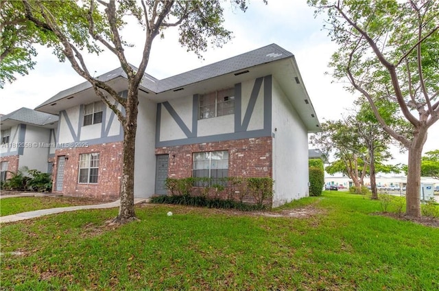 7503 Kimberly Blvd Unit 114, North Lauderdale, FL 33068 - english style home with brick siding, stucco siding, and a front lawn