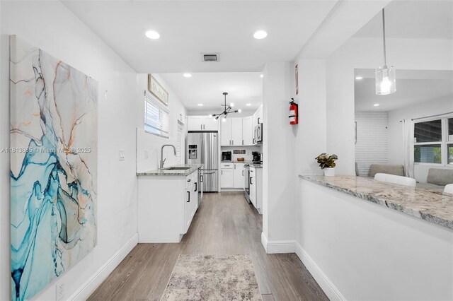 1013 S 24th Ave, Hollywood, FL 33020 - hall featuring a sink, a chandelier, light wood-style floors, baseboards, and recessed lighting