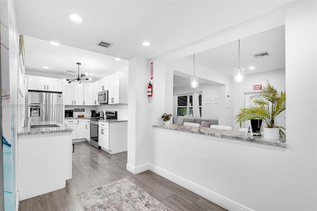 1013 S 24th Ave, Hollywood, FL 33020 - kitchen with stainless steel appliances, a chandelier, wood finished floors, baseboards, and recessed lighting