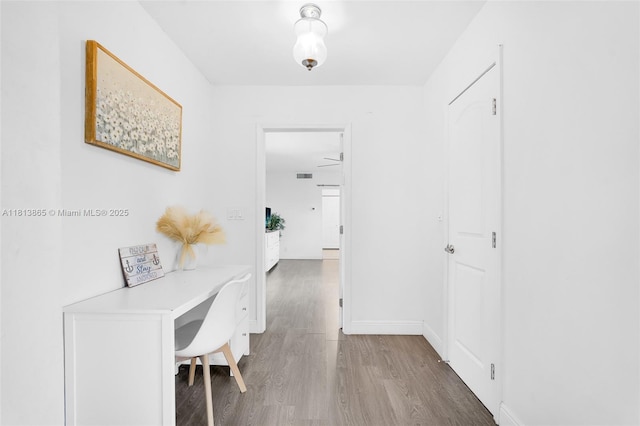 1013 S 24th Ave, Hollywood, FL 33020 - hall featuring wood finished floors, a desk, and baseboards
