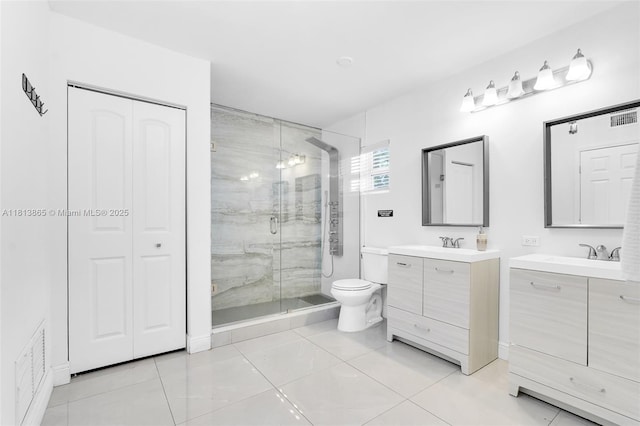 1013 S 24th Ave, Hollywood, FL 33020 - full bath featuring a stall shower, two vanities, tile patterned floors, toilet, and a closet
