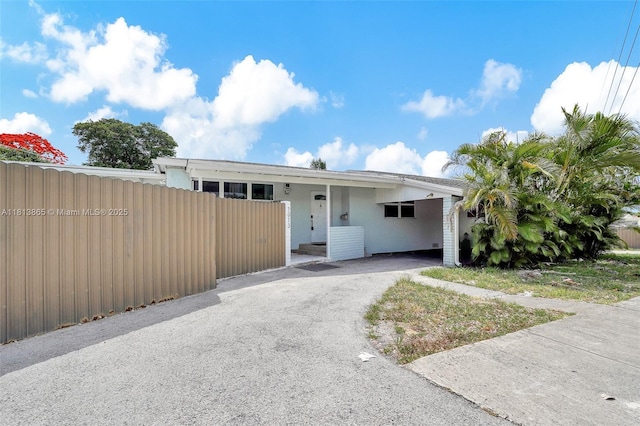 1013 S 24th Ave, Hollywood, FL 33020 - view of front of house with driveway, a carport, and stucco siding