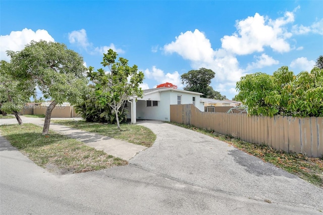 1013 S 24th Ave, Hollywood, FL 33020 - view of front of home featuring asphalt driveway, stucco siding, and a carport