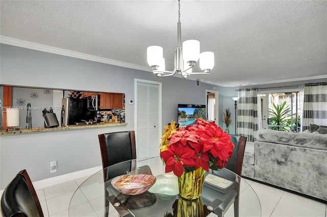 14001 SW 91st Ter Unit 14001, Miami, FL 33186 - dining space featuring a chandelier, a textured ceiling, ornamental molding, light tile patterned floors, and baseboards