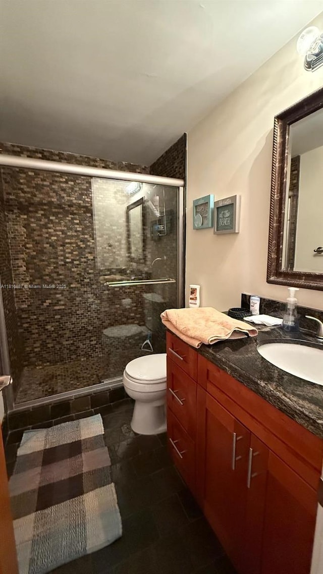 3505 S Ocean Dr Unit 1010, Hollywood, FL 33019 - full bath featuring toilet, vanity, a shower stall, and tile patterned floors