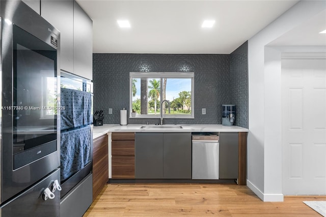 9310 Sunrise Lakes Blvd Unit 206, Sunrise, FL 33322 - kitchen with a sink, light countertops, light wood-type flooring, and modern cabinets