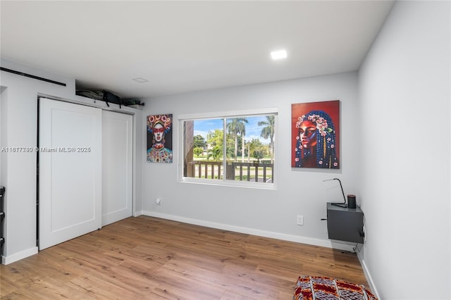 9310 Sunrise Lakes Blvd Unit 206, Sunrise, FL 33322 - unfurnished bedroom with wood finished floors and baseboards
