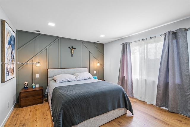 9310 Sunrise Lakes Blvd Unit 206, Sunrise, FL 33322 - bedroom with a decorative wall, light wood-style floors, and baseboards