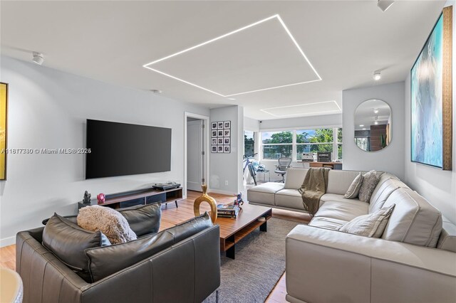 9310 Sunrise Lakes Blvd Unit 206, Sunrise, FL 33322 - living room featuring wood finished floors, attic access, and baseboards