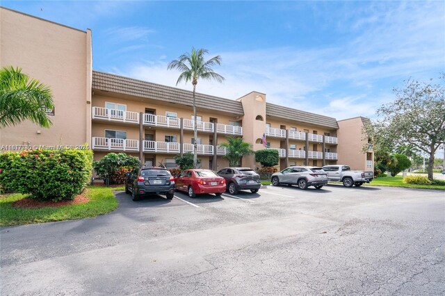 9310 Sunrise Lakes Blvd Unit 206, Sunrise, FL 33322 - view of apartment building / complex featuring uncovered parking