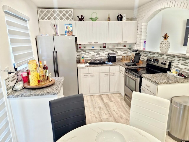 1720 SW 64th Ave, North Lauderdale, FL 33068 - kitchen featuring stainless steel electric range, freestanding refrigerator, a sink, tasteful backsplash, and light wood-type flooring