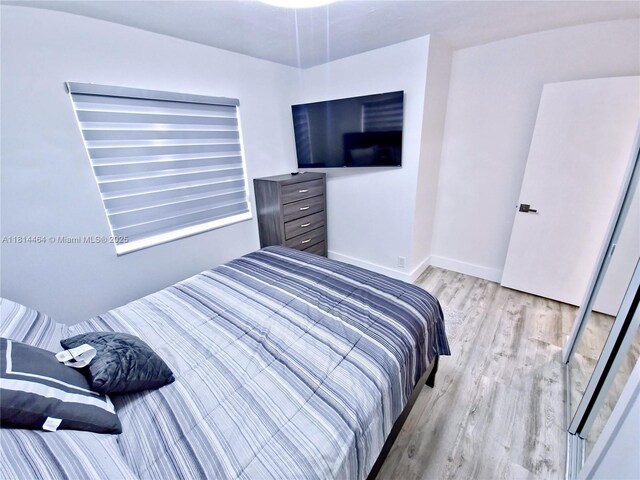 1720 SW 64th Ave, North Lauderdale, FL 33068 - bedroom featuring light wood-style flooring and baseboards