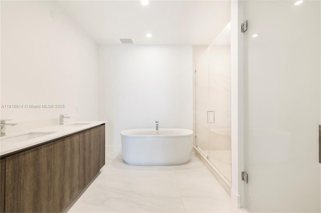 17550 Collins Unit 1604, Sunny Isles Beach, FL 33160 - full bath featuring a freestanding tub, marble look tile flooring, a shower stall, recessed lighting, and double vanity