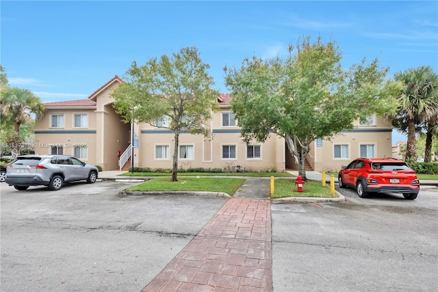 1103 Golden Lakes Blvd Unit 1013, West Palm Beach, FL 33411 - multi unit property featuring stairs, uncovered parking, and stucco siding
