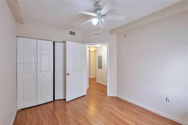 1103 Golden Lakes Blvd Unit 1013, West Palm Beach, FL 33411 - unfurnished bedroom featuring electric panel, light wood finished floors, baseboards, a closet, and a ceiling fan