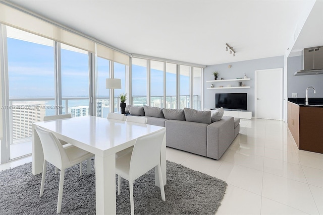 495 Brickell Ave Unit 5104, Miami, FL 33131 - dining space featuring a water view, a wall of windows, rail lighting, and light tile patterned floors