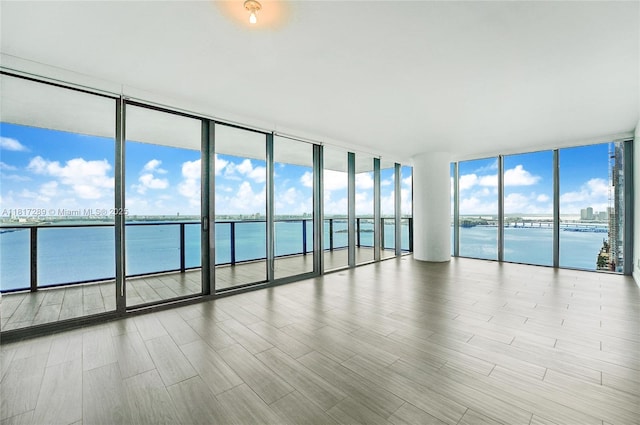 3131 NE 7th Ave Unit 3101, Miami, FL 33137 - unfurnished room featuring a water view, floor to ceiling windows, and wood finished floors