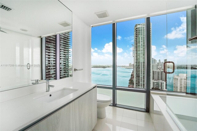 3131 NE 7th Ave Unit 3101, Miami, FL 33137 - full bath with vanity, toilet, tile patterned floors, floor to ceiling windows, and a tub