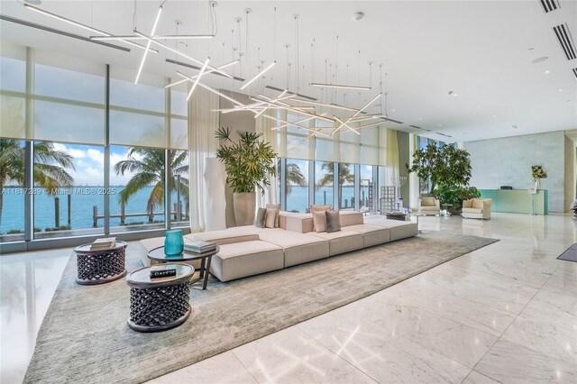 3131 NE 7th Ave Unit 3101, Miami, FL 33137 - community lobby with a high ceiling, a wall of windows, and a water view