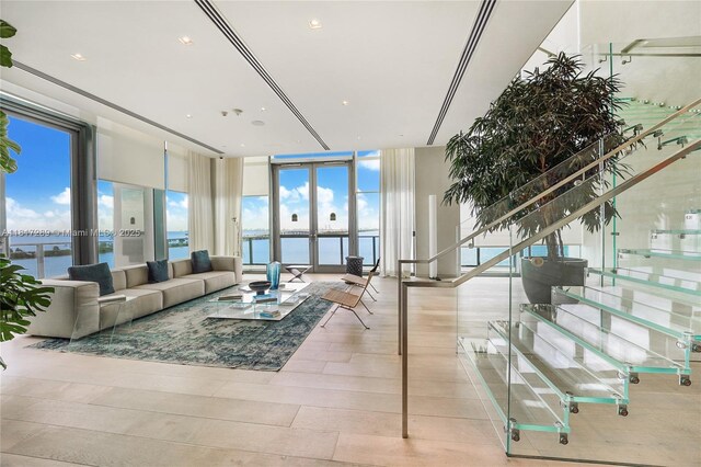 3131 NE 7th Ave Unit 3101, Miami, FL 33137 - living room featuring stairs, a water view, french doors, and light wood finished floors